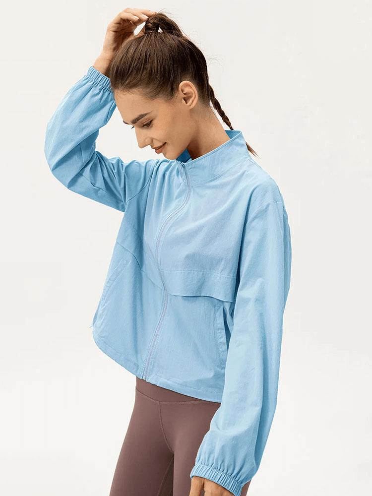 Blue women's windbreaker with UV protection, lightweight and breathable for running, featuring a turn-down collar. Perfect for outdoor activities.